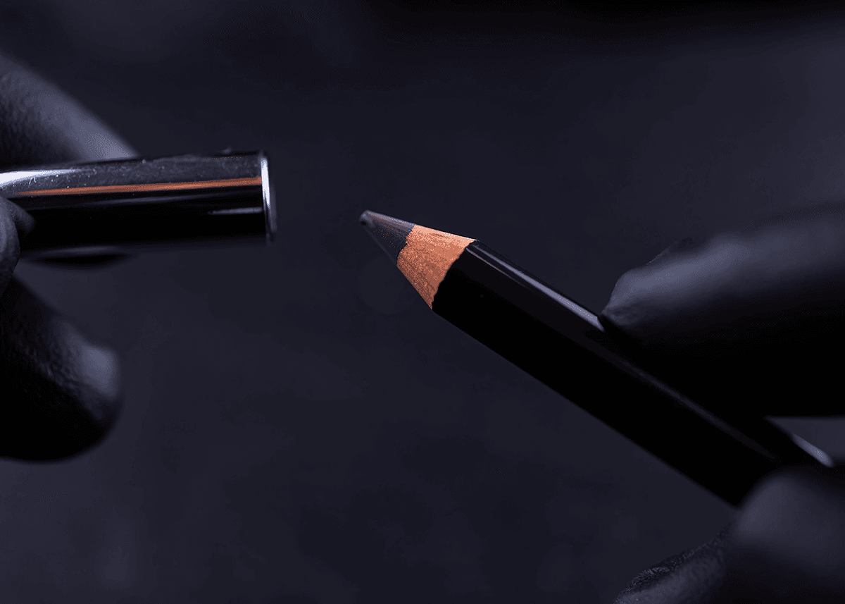 Pencil black eyeliner with black gloves