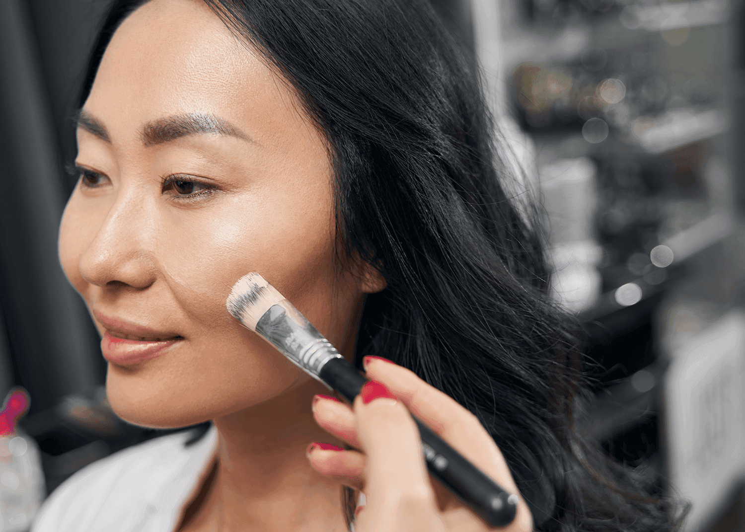 Woman Applying Foundation on Skin