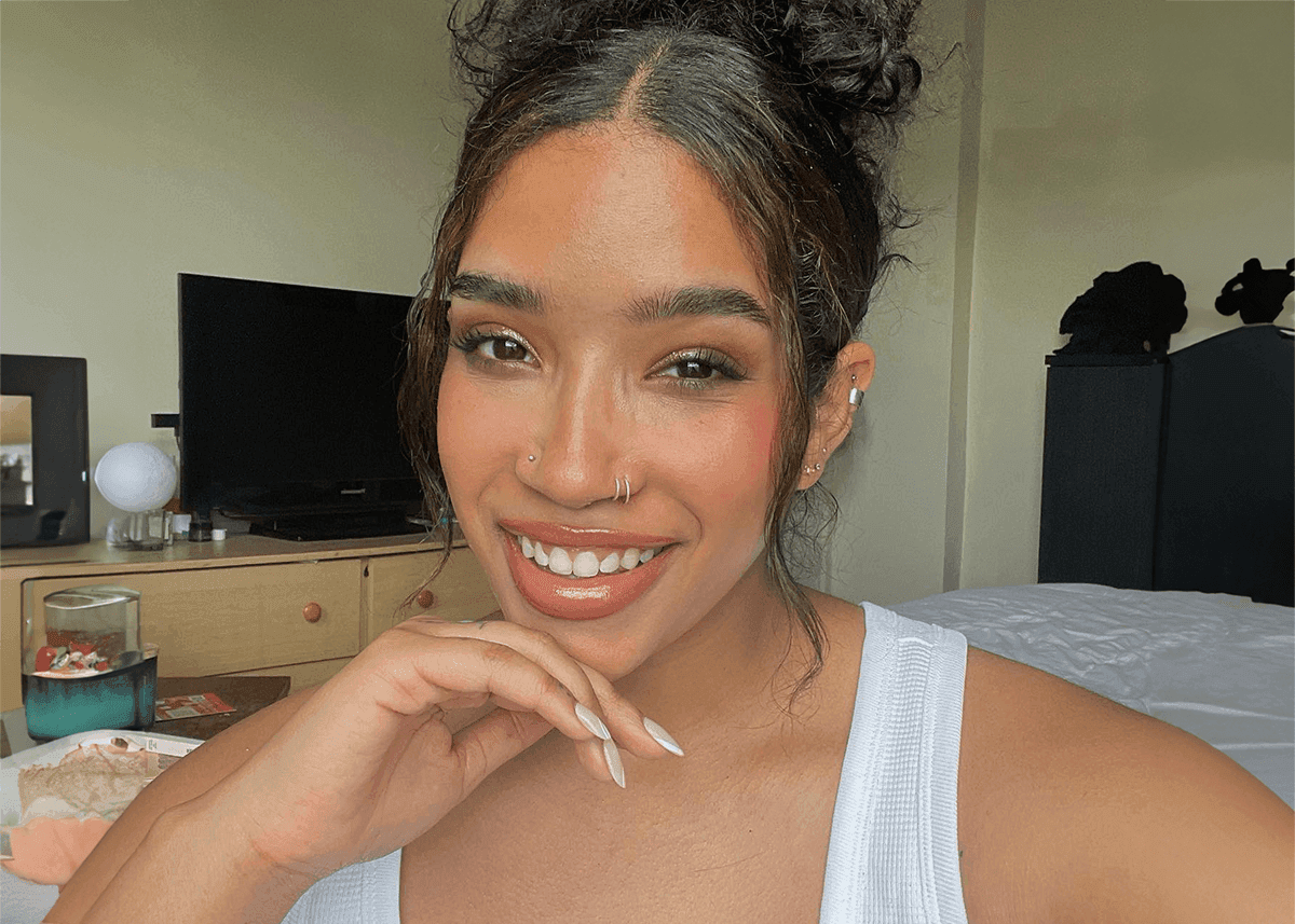 A woman with different skin tones applying bronzer to her face