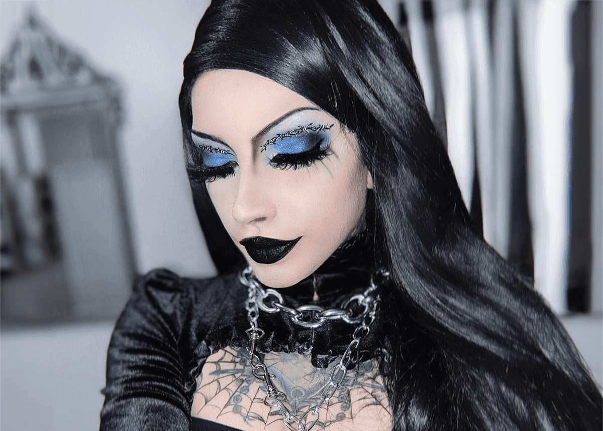 A woman accessorizing her goth makeup look