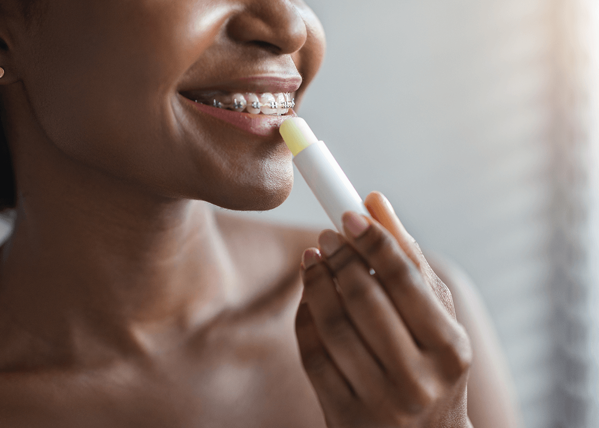 African American Woman Applying Lip Primer