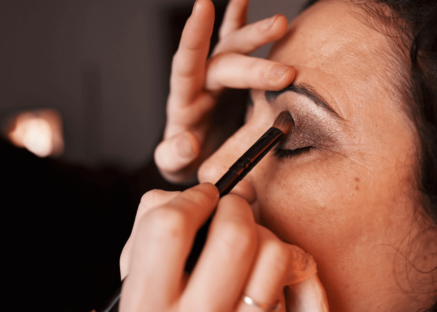 Close up of Mature Makeup Artist Applying Makeup