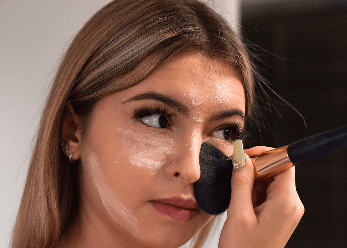 Girl Spreading out Makeup with Brushes