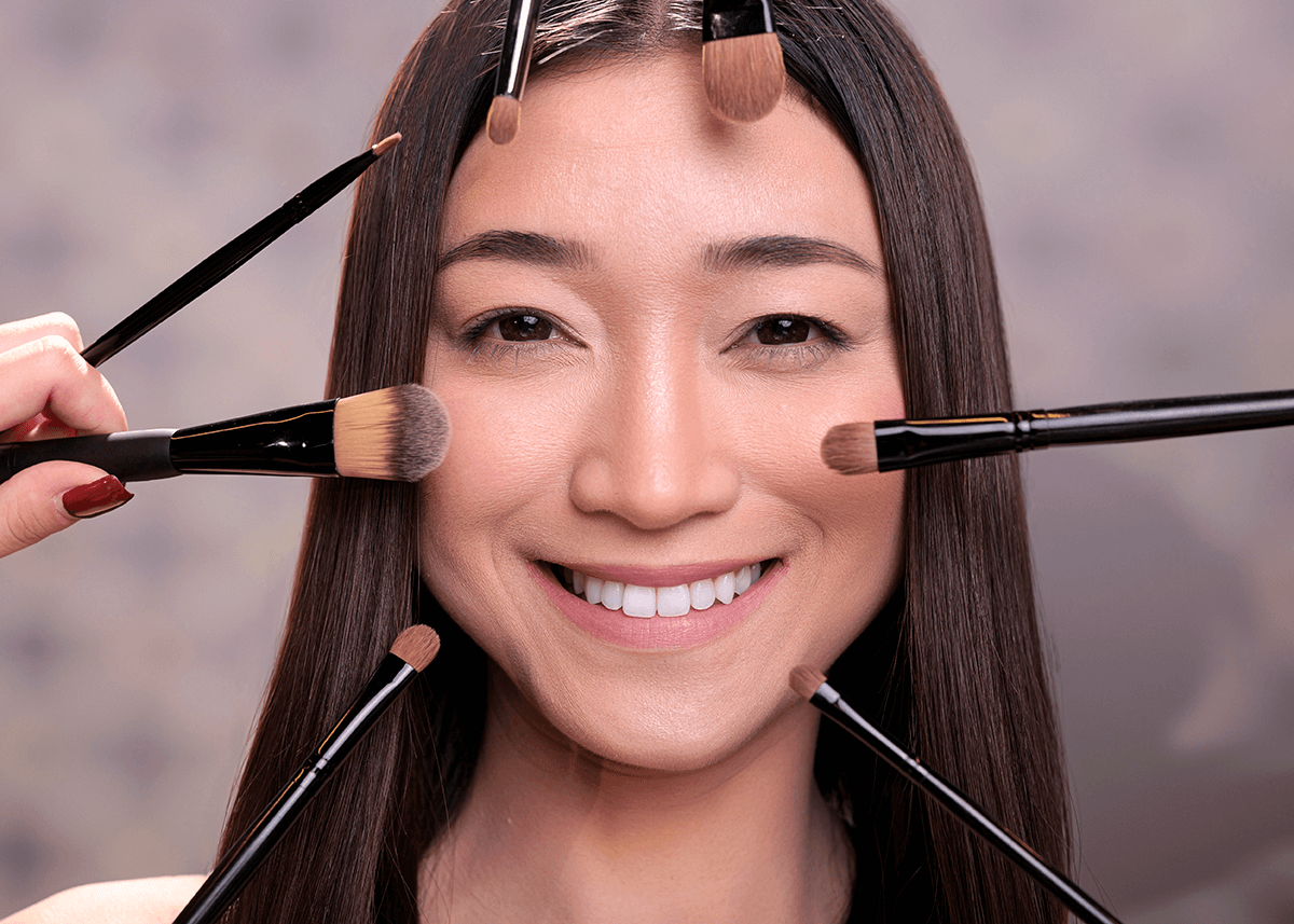 Makeup Artist Hands Holding Brushes Applying Blush