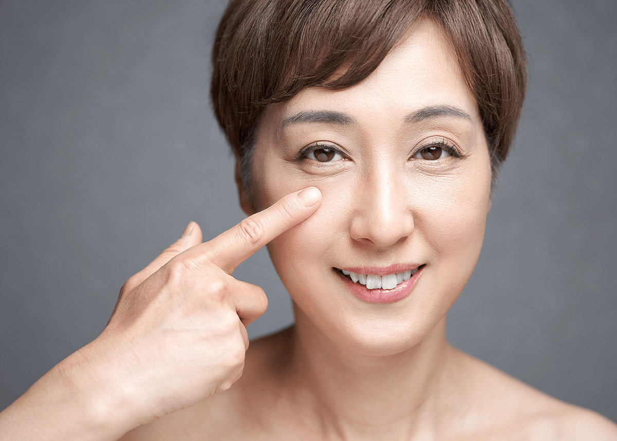 Middle Aged Japanese Woman Holding Her Eye