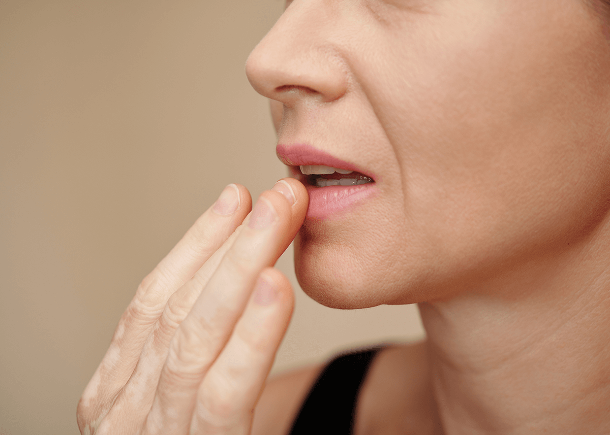 Woman applying nourishing lip balm for soft lips