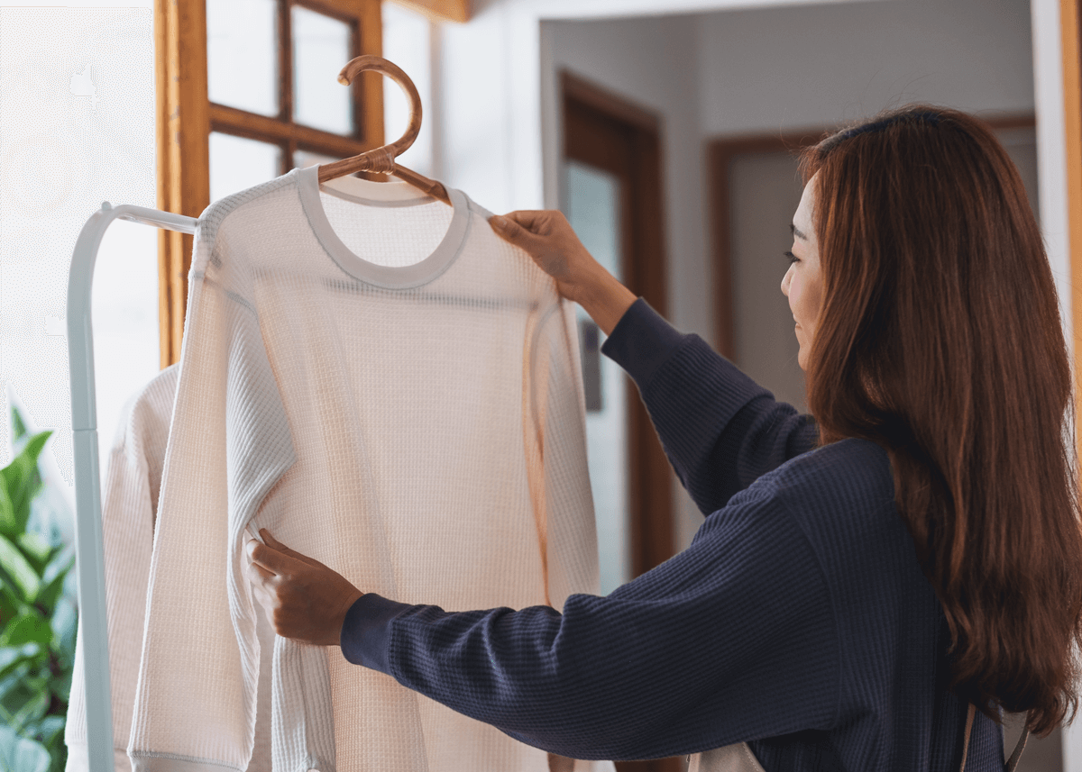Woman hanging clean shirt