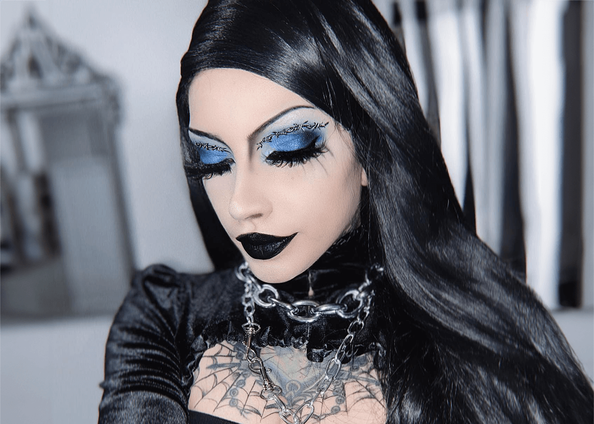 A woman accessorizing her goth makeup look