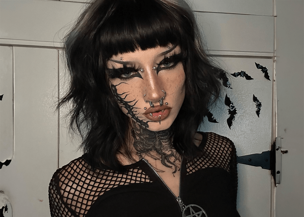 Woman tattoos on face goth makeup