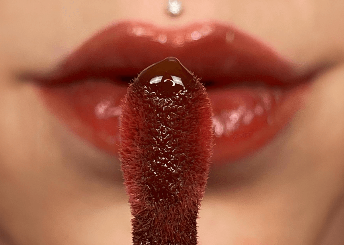 Closeup of Lip Oil with Lips in Background